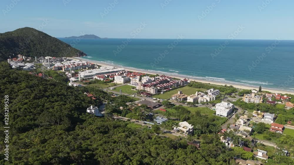 Close-up view of Praia Brava in Florianópolis, featuring luxurious condominiums and its stunning turquoise waters. Close-up view of Praia Brava in Florianópolis, featuring luxurious condominiums and its stunning turquoise waters.