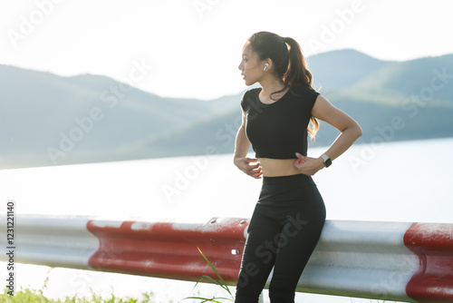 A woman in sportswear running in the park, enjoying fresh air, engaging in outdoor activities to maintain a healthy lifestyle, boosting cardiovascular health, and feeling happy and energetic photo