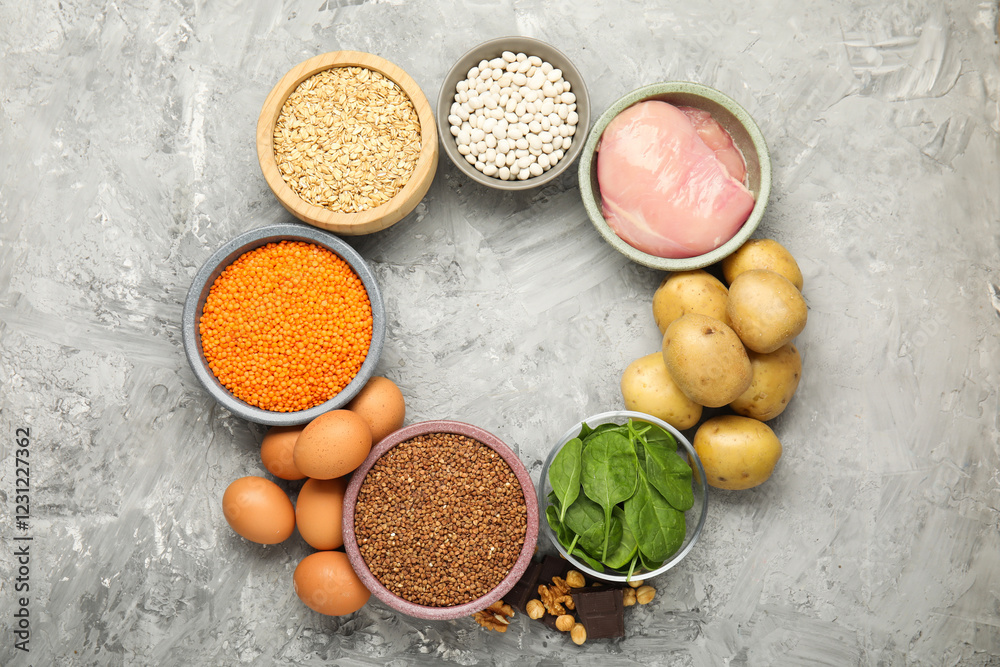 Diet plan for anemia. Different products rich in iron on grey table, flat lay. Space for text Diet plan for anemia. Different products rich in iron on grey table, flat lay. Space for text