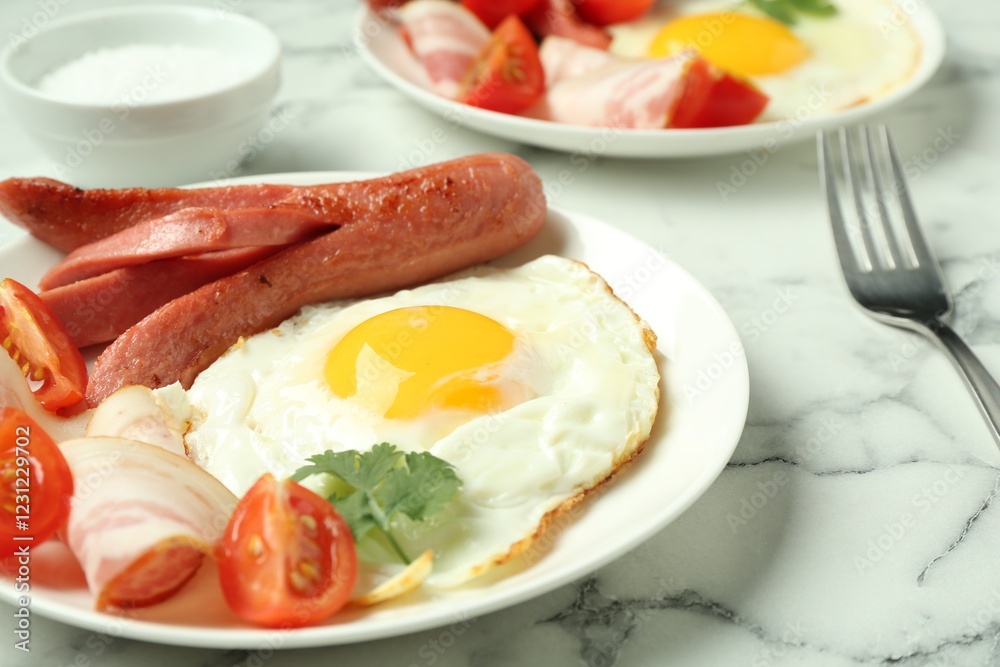 Tasty brunch. Fried egg, sausage, bacon and tomatoes on white marble table, closeup Tasty brunch. Fried egg, sausage, bacon and tomatoes on white marble table, closeup