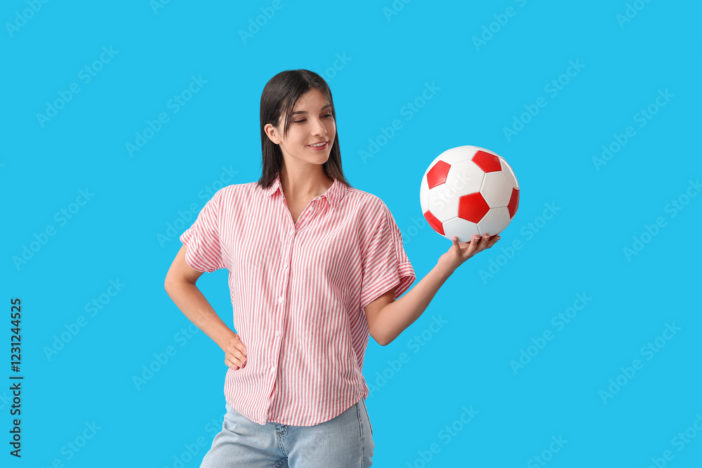 Young woman with soccer ball on blue background Young woman with soccer ball on blue background