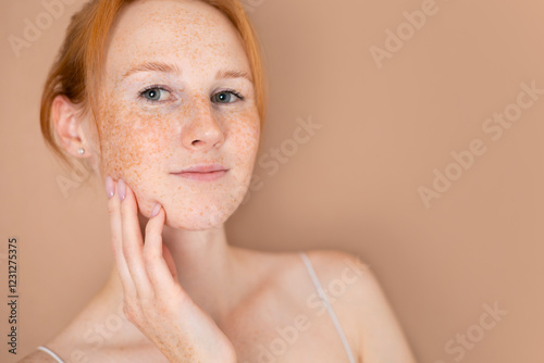 Photos close-up portrait of a red-haired young beautiful girl with freckles