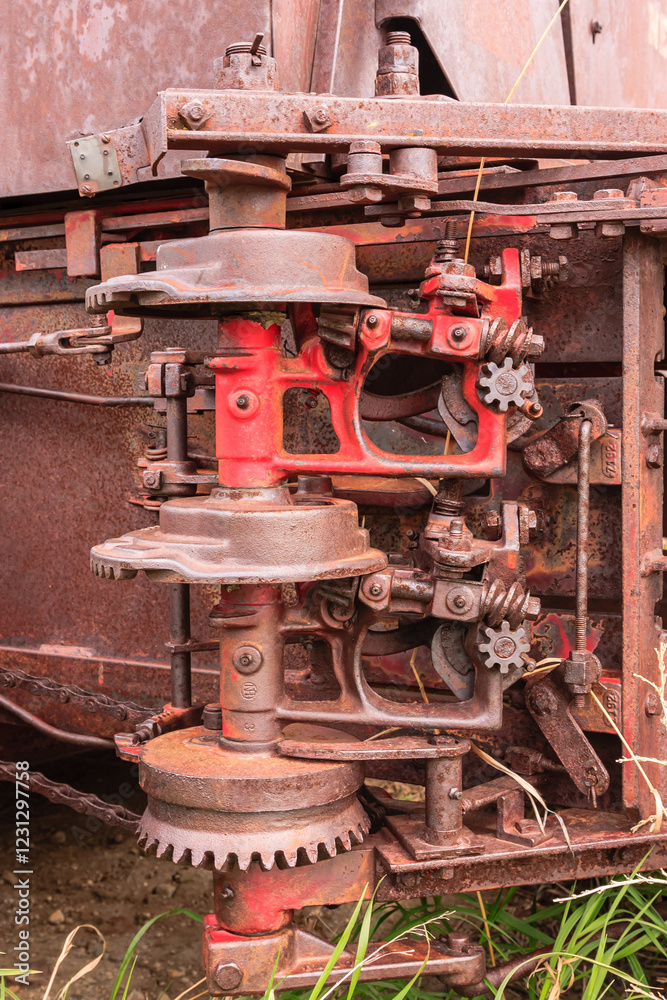 A rusty old machine with a red gear A rusty old machine with a red gear