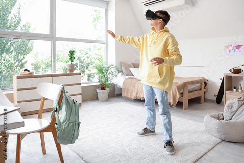Teenage boy using VR glasse...