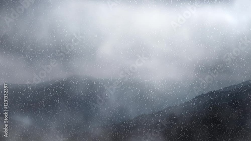 Stormy snowy foggy mountain landscape, majestic Forest Covered in Mist and Shrouded by Clouds - looped 4K