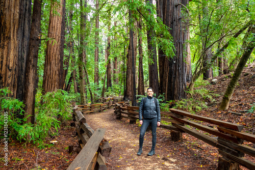 beautiful female hiker on path in the woods (redwood tree) of Julia Pfeiffer Burns State Park