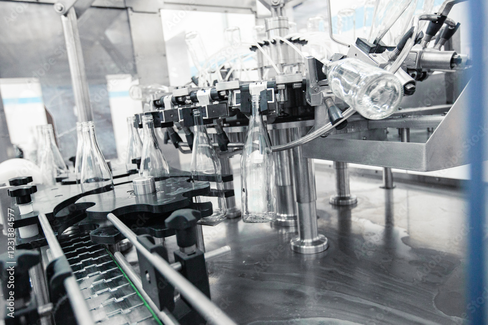 Fototapeta premium Advanced machinery for bottling beverages in a modern production facility during daylight hours