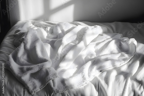 White towel on the white bed photo