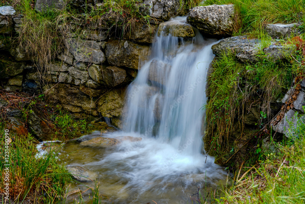 Water flowing from the mountain and creating silky waterfalls. Nature Water flowing from the mountain and creating silky waterfalls. Nature