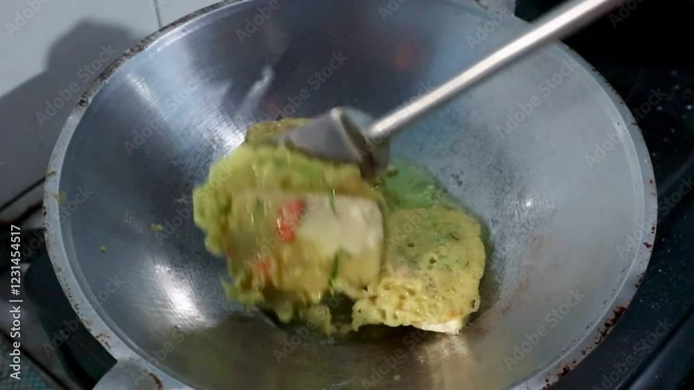 Close-up view of mendoan tempe fried in a frying pan with hot cooking oil