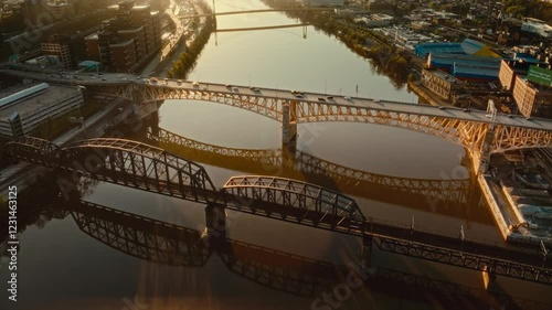 4K droneflying over bridge Pittsburgh, Pennsylvania. Sunset commute. The iconic bridge reflects in the water. photo