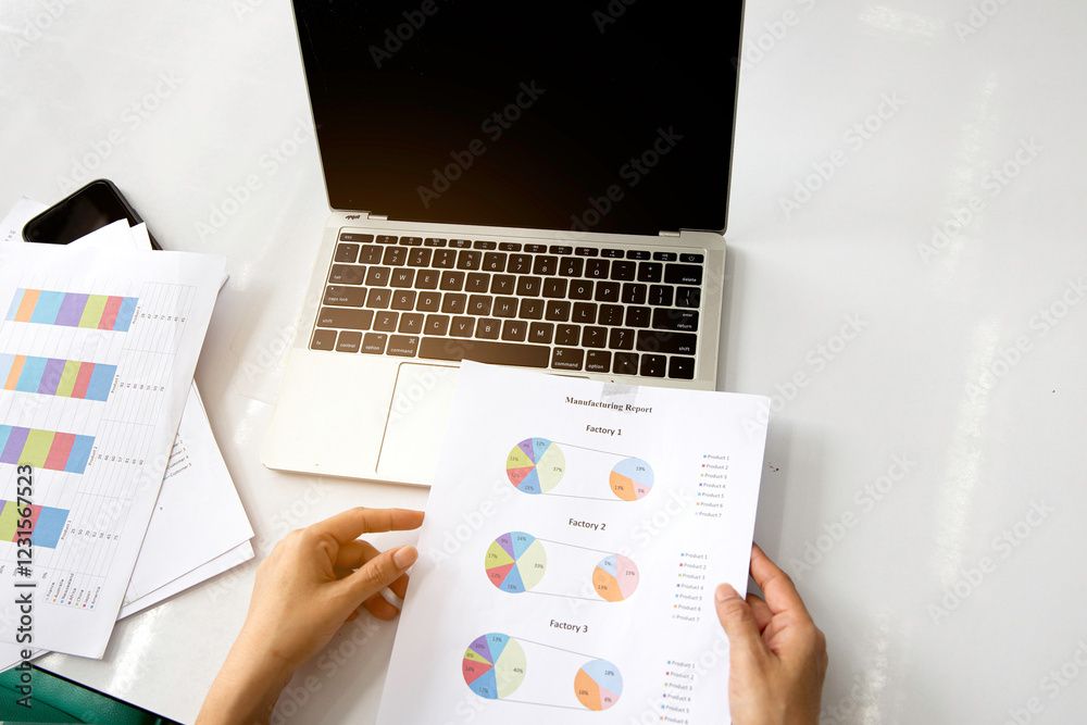 Business woman work at office with laptop and report finance, sales summary document on table.