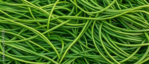 Green garlic scapes piled high, farm harvest photo