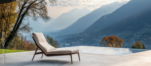 Elegant outdoor lounge chair on a modern terrace overlooking scenic mountains and a tranquil pool reflecting soft sunset hues.
