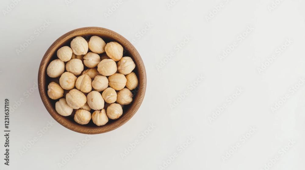 wooden bowl filled with macadamia nuts arranged neatly, showcasing their natural texture and color. This evokes sense of simplicity and health wooden bowl filled with macadamia nuts arranged neatly, showcasing their natural texture and color. This evokes sense of simplicity and health