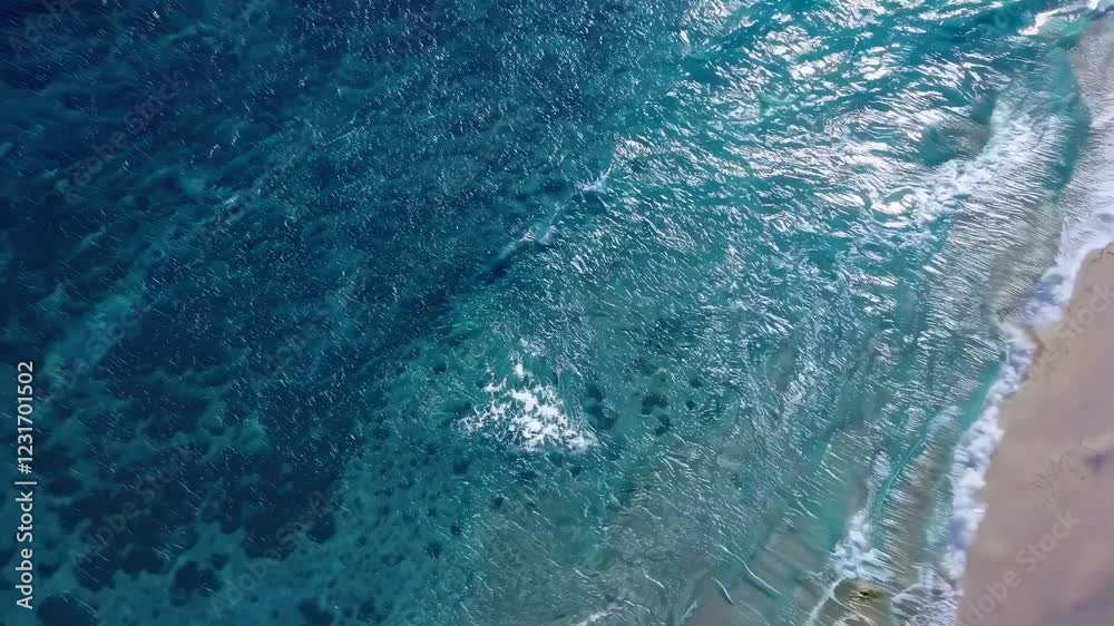 Aerial video capturing serene beach waves gently washing ashore, showcasing natural beauty from a high, sweeping camera angle. Aerial video capturing serene beach waves gently washing ashore, showcasing natural beauty from a high, sweeping camera angle.