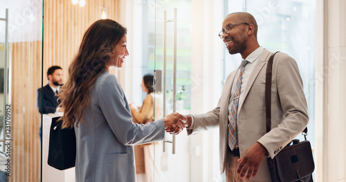 Handshake, smile and welcome with business people in lobby of office for friendly greeting. Agreement, hello or introduction with human resources manager and employee shaking hands at orientation