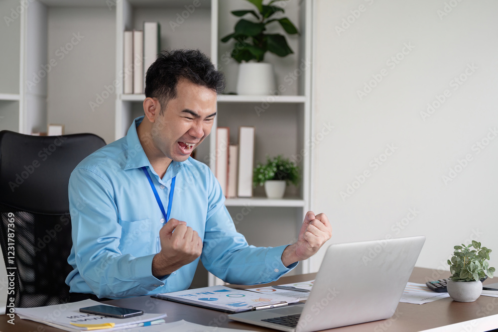 Excited business professional celebrating success at a desk, showcasing enthusiasm and achievement in a modern office environment. Excited business professional celebrating success at a desk, showcasing enthusiasm and achievement in a modern office environment.