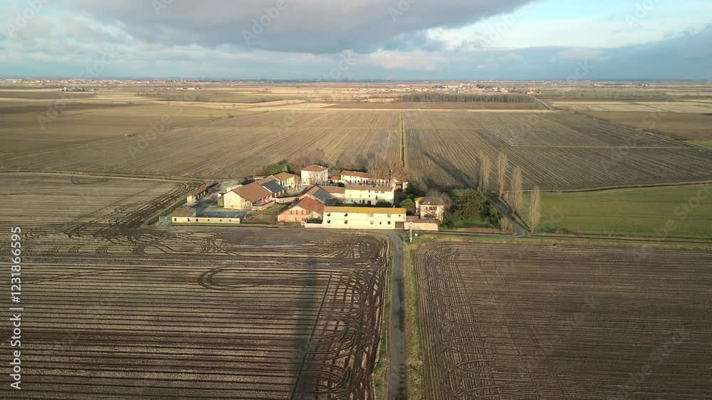 Drone point of view of the winter countryside around the city of Novara (Piedmont Region, Northern Italy); with Vercelli and Pavia, is famous for valuable and particular types of rice cultivation.