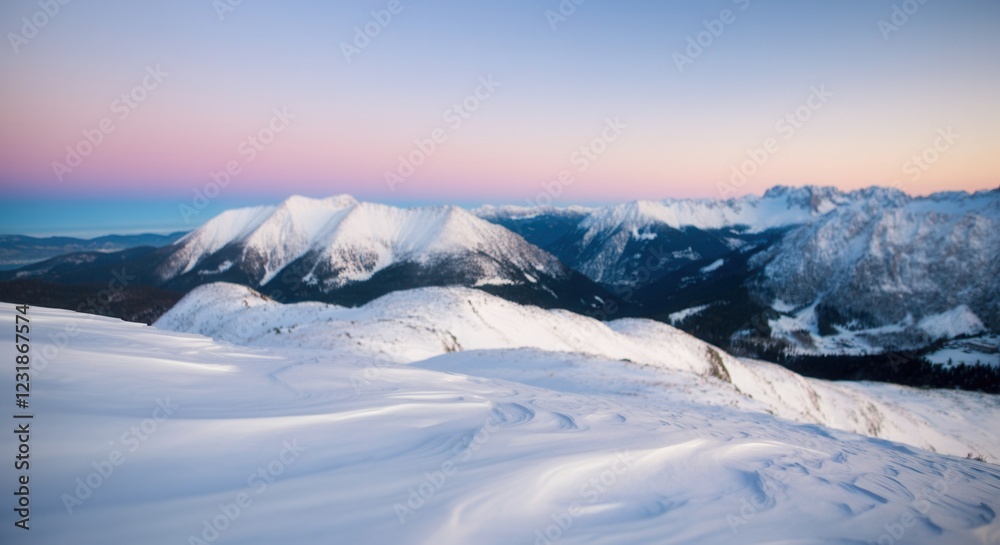 Fototapeta premium Serene winter landscape with snow-covered mountains at sunset