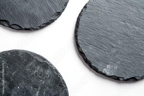 Close-up photo of three slate coasters arranged on a table
