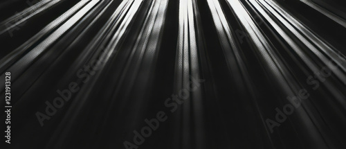 Unique rays of light create dramatic illumination against a black background