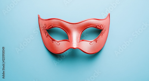 Intricate red masquerade mask set against a serene pastel blue background for festive celebration
