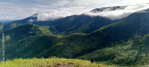 mountains and beautiful expanses of savanna accompanied by lumpy clouds in Indonesia,