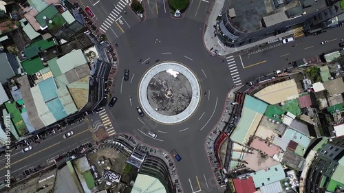 Aerial 4K footage of Chiayi city in Taiwan. Top down view of the city center with many cars on the road. photo