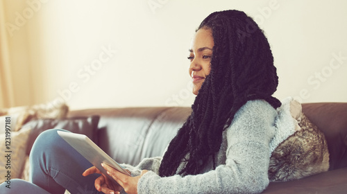 Tablet, smile and thinking with woman on sofa for college application, University portal and reflection. Vision, idea and academy admission with African person in living room at home for update