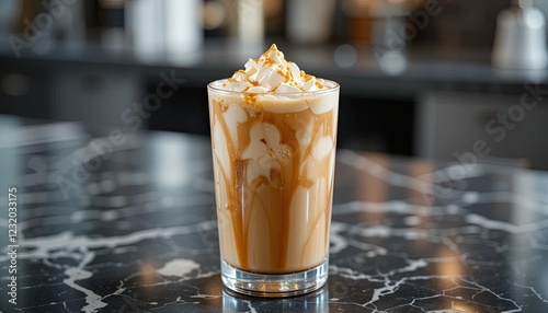 fLuxurious Iced Caramel Macchiato in Clear Glass, Beautifully Presented on Marble Countertop, Perfect for Culinary Photography. photo