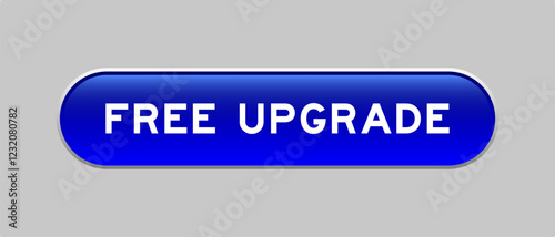 Blue color capsule shape button with word free upgrade on gray background