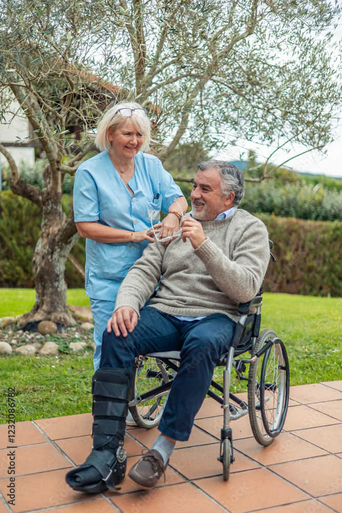 vertical Compassionate Nurse Assisting Elderly Man in Wheelchair vertical Compassionate Nurse Assisting Elderly Man in Wheelchair