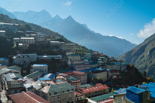 Namche Bazaar settlement on Everest Base Camp (EBC) trekking route and snowy Thamserku 6608m mountain on the background. Sagarmatha National Park, Nepal. photo