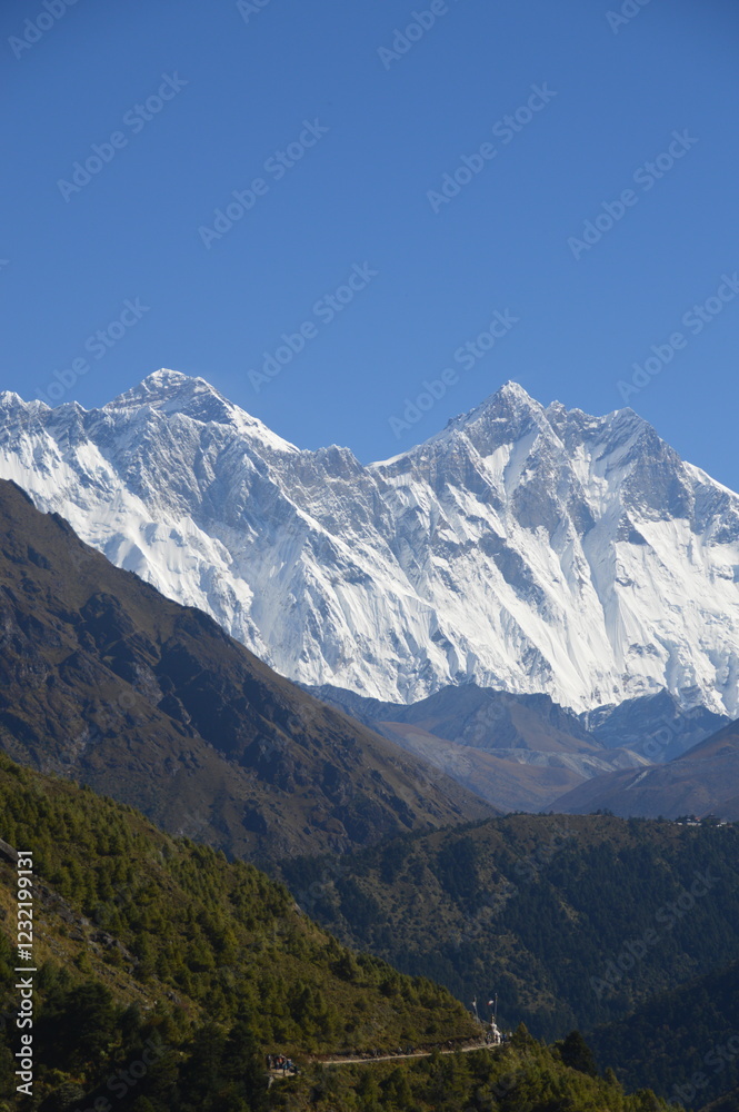 Hiking in the stunning Khumbu Valley surrounded by glaciars and snowy peaks in the Himalayan Everest Base Camp Trek Hiking in the stunning Khumbu Valley surrounded by glaciars and snowy peaks in the Himalayan Everest Base Camp Trek