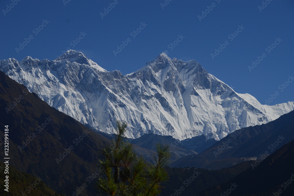 Hiking in the stunning Khumbu Valley surrounded by glaciars and snowy peaks in the Himalayan Everest Base Camp Trek Hiking in the stunning Khumbu Valley surrounded by glaciars and snowy peaks in the Himalayan Everest Base Camp Trek