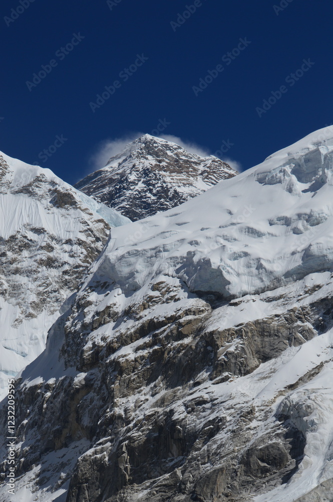 Mount Everest and the Khumbu Icefall Glacier as seen from the valley on the Everest Base Camp Trek, Nepal Mount Everest and the Khumbu Icefall Glacier as seen from the valley on the Everest Base Camp Trek, Nepal