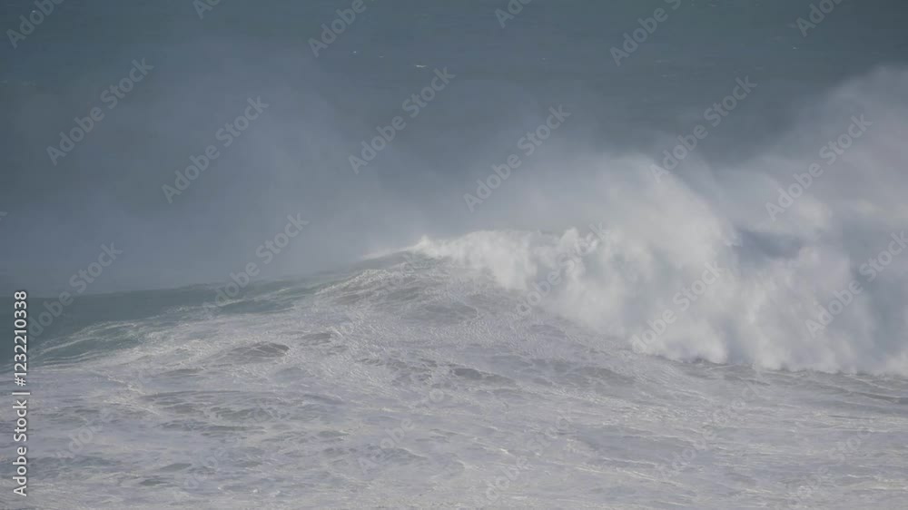 Huge waves crashing at Nazare, Portugal, creating a powerful and dramatic ocean scene Huge waves crashing at Nazare, Portugal, creating a powerful and dramatic ocean scene