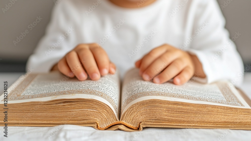 Child reading a book with small hands turning pages - education and learning concept Child reading a book with small hands turning pages - education and learning concept