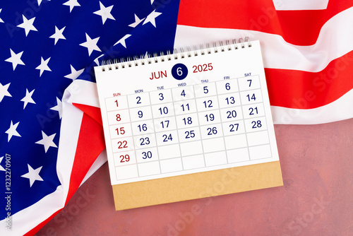 June 2025 Monthly desk calendar and United States of America flag. photo