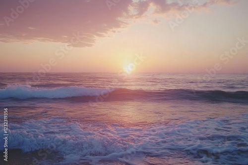 Beautiful sunset over calm ocean waves at beach during twilight hours