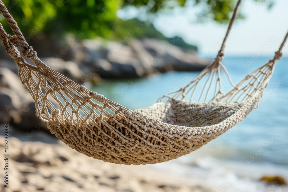 Obraz premium Relaxing hammock hanging by the beach with serene ocean view on a sunny day