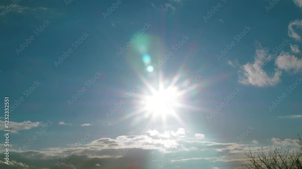 Sunlight in the sky above the tree branches, the sun shining brightly, the rays reflecting on the lens. High quality 4k footage