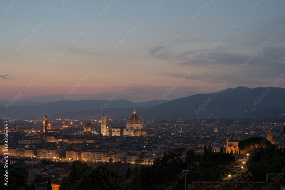 Obraz premium Florence illuminated by vibrant fireworks during the Feast of St. John, its patron saint, on June 24th. The iconic Duomo and Ponte Vecchio glow under the night sky, reflecting in the Arno River.
