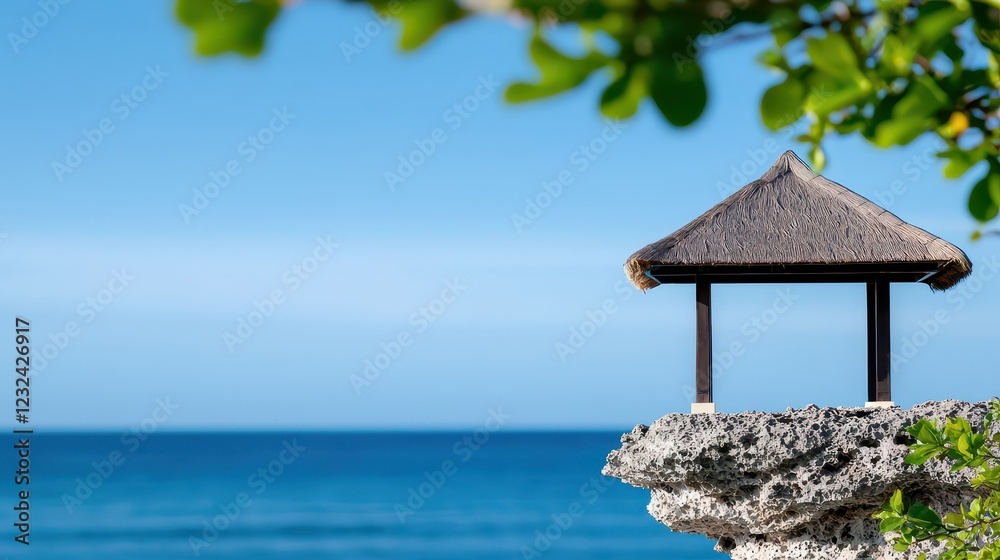 A tranquil beachside hut overlooking the calm ocean, surrounded by lush greenery and clear blue skies. A tranquil beachside hut overlooking the calm ocean, surrounded by lush greenery and clear blue skies.