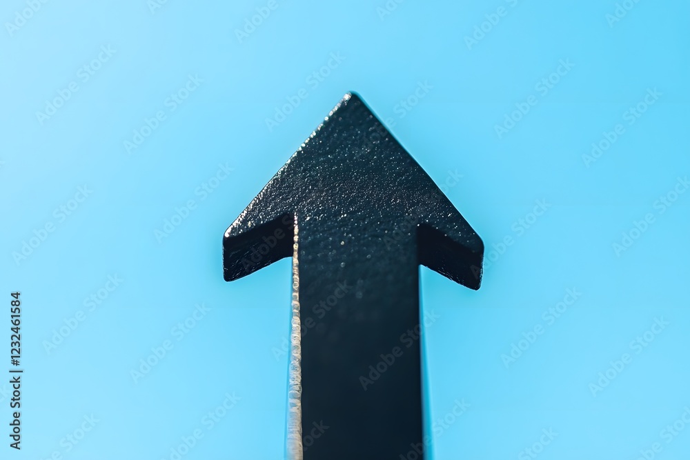 Naklejka premium Bold Black Upward Arrow on Light Sky Blue Background, Representing Business Growth and Progress.