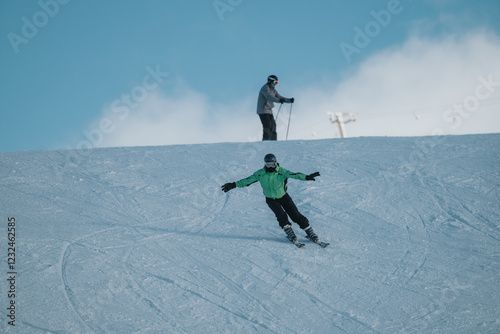 Wallpaper Mural Two individuals skiing on a snowy slope with clear skies and a vibrant atmosphere, highlighting nature, sport, and an outdoor winter adventure. Torontodigital.ca