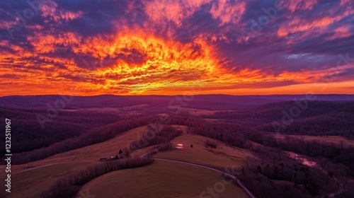 Aerial capture of rolling clouds glowing in fiery orange during sunset