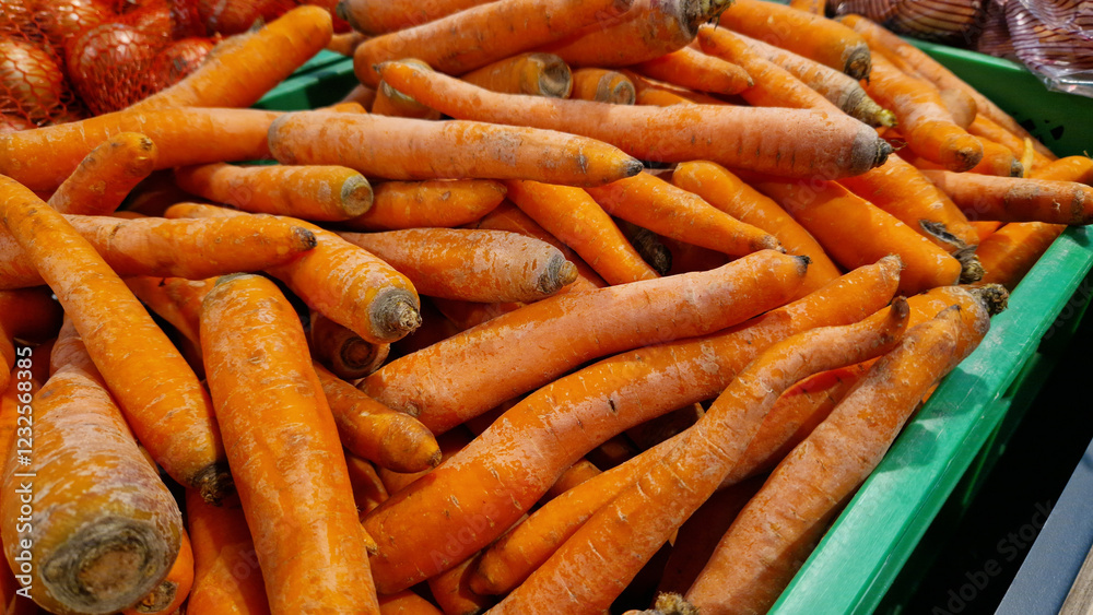 Washed ripe carrots on sale in the store. Carrots close-up. Vegetable crop. A pile of washed carrots in a plastic box, selective focus. Vegetables in the supermarket close-up Washed ripe carrots on sale in the store. Carrots close-up. Vegetable crop. A pile of washed carrots in a plastic box, selective focus. Vegetables in the supermarket close-up
