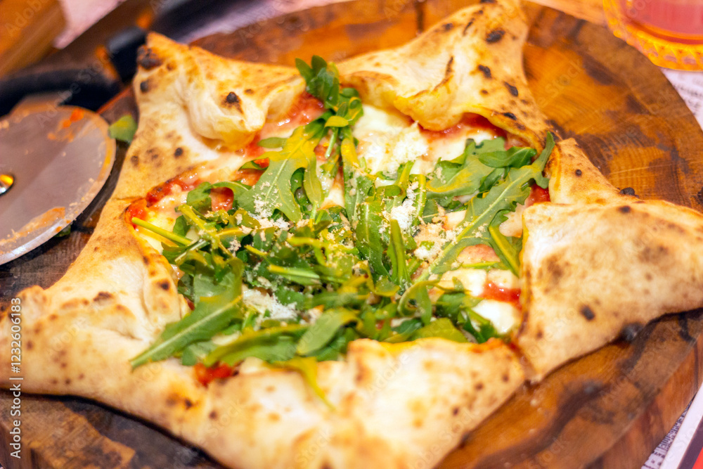 star-shaped italian pizza with tomatoes and arugula star-shaped italian pizza with tomatoes and arugula